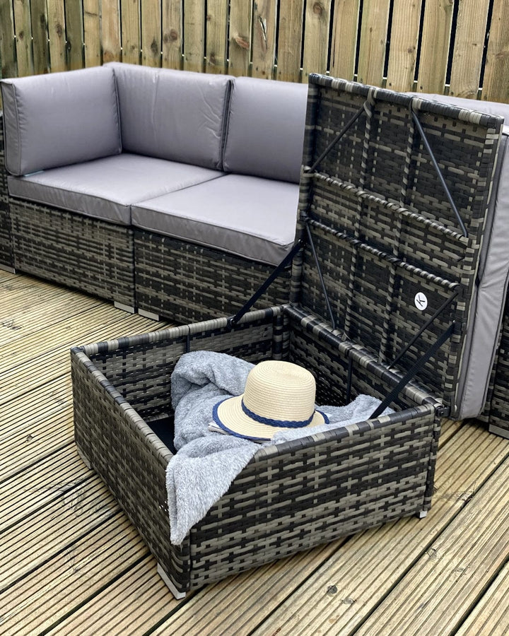 detail shot of ottoman opened up and storing grey blanket and sun hat inside