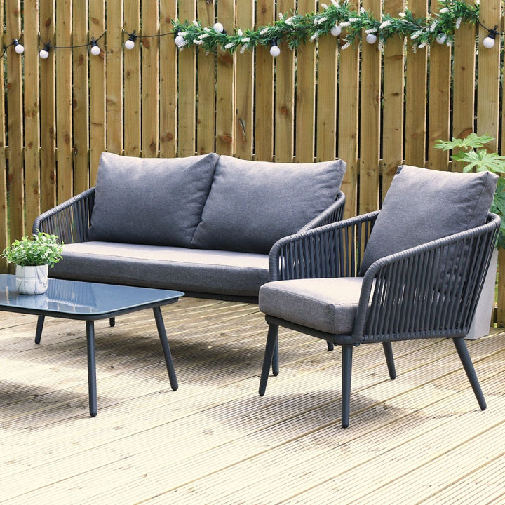 teramo sofa set on garden decking with festoon lights and plant pot in the background, small chive planter on glass table top