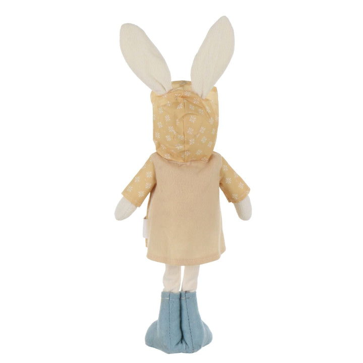 back view of plush duck with soft bunny ears wearing yellow floral raincoat and blue wellie boots
