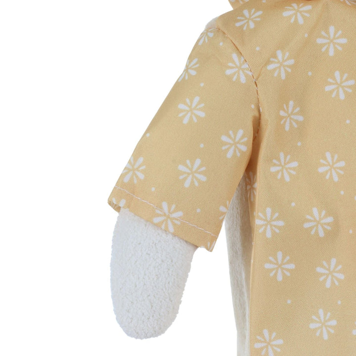 Close-up of a yellow raincoat on duck with white floral patterns on a white background