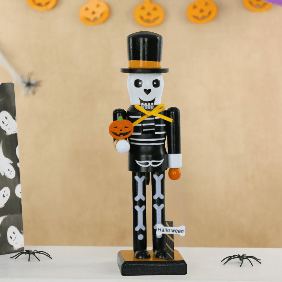 Halloween-themed nutcracker with skeleton design holding a pumpkin, against a beige background with Halloween decorations.
