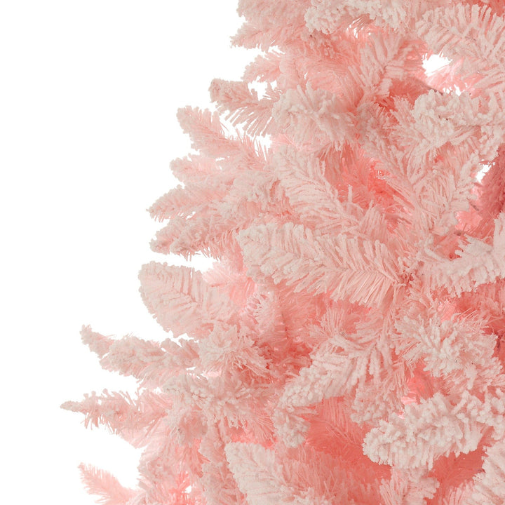 Close-up of a pink artificial Christmas tree with lights on a white background