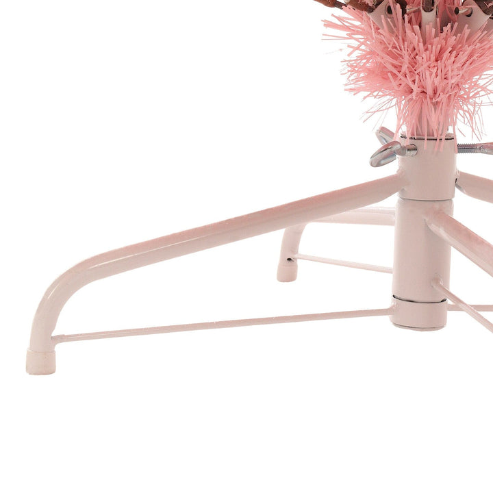Pink metal tree stand with decorative pink branches on a white background