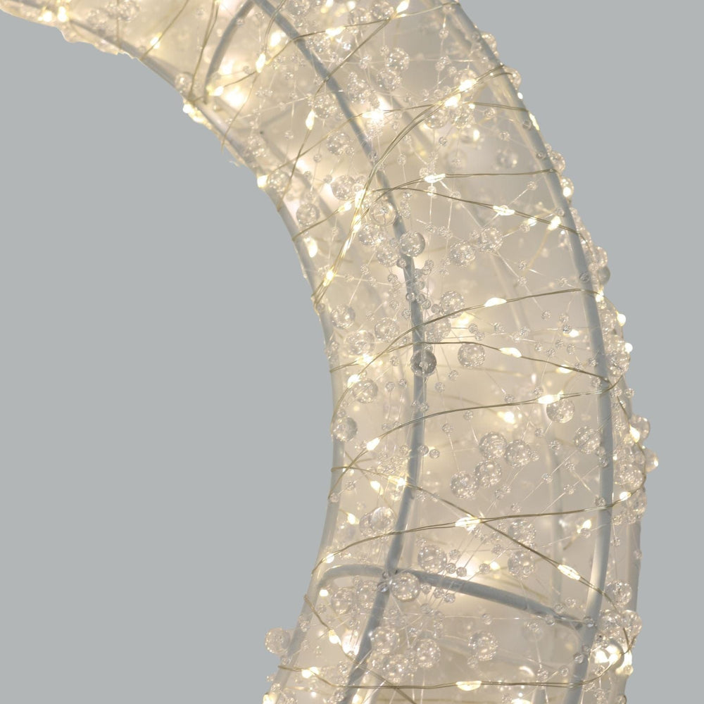 Decorative wreath with lights on a plain background