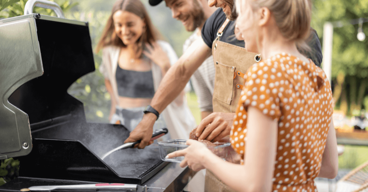 charcoal smoker bbq in garden with smoke coming from the grill