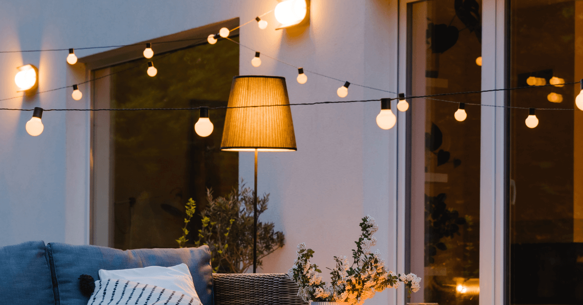 multi colour festoon lights on garden wall