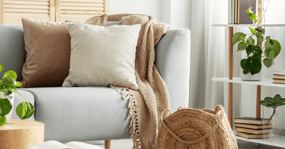 yellow and grey cushion on a cream coloured sofa