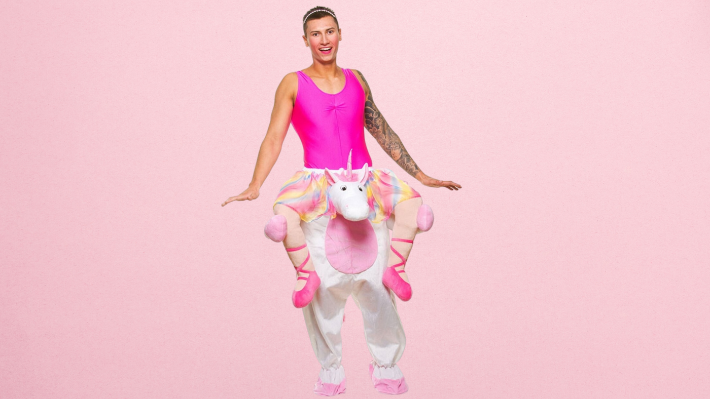 man wearing pink unicorn carry me costume on a pink background