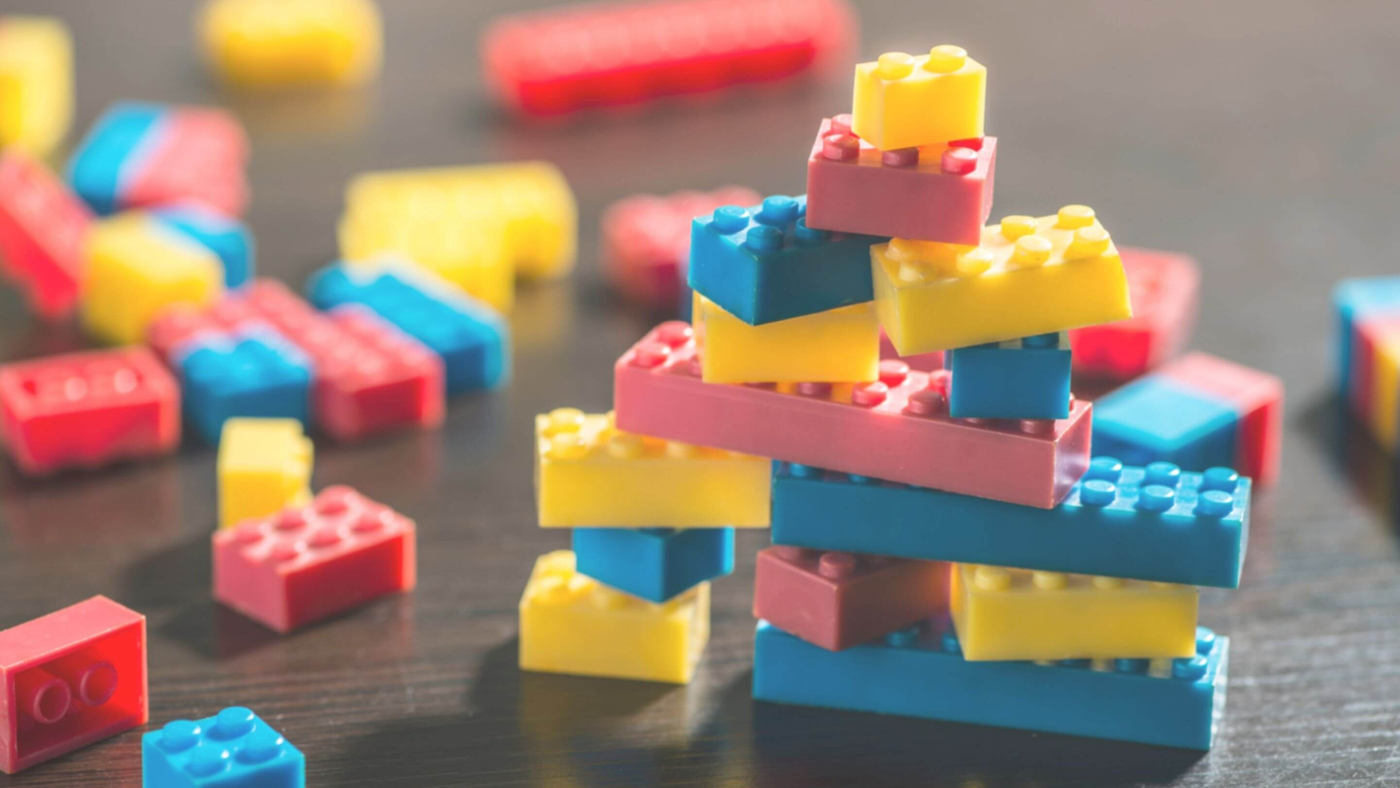lego pieces in yellow, blue and red colours stacked on top of each other