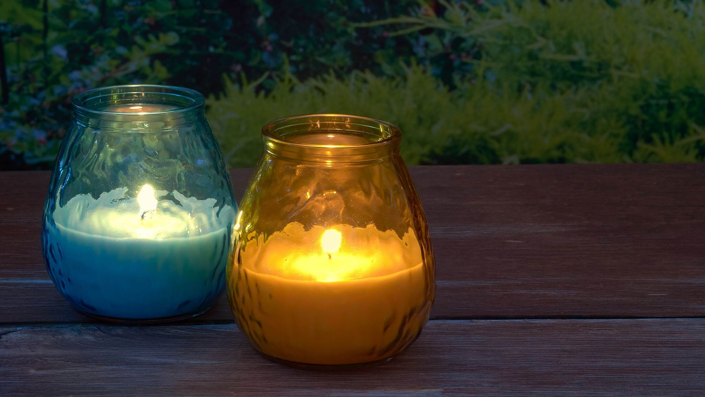 blue and yellow outdoor candles on wooden patio space