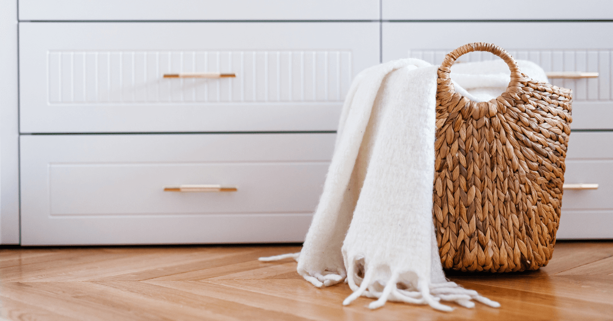 person taking laundry from laundry basket and putting it inside the washing machine