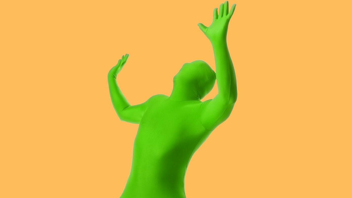 man wearing second skin tight green body suit on an orange background