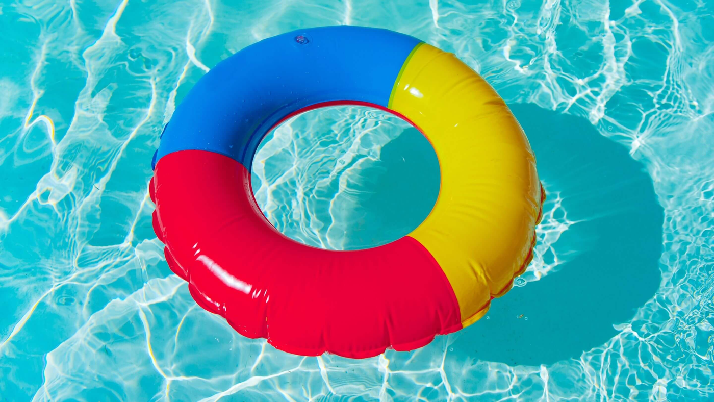 multi colour inflatable ring pool float in swimming pool