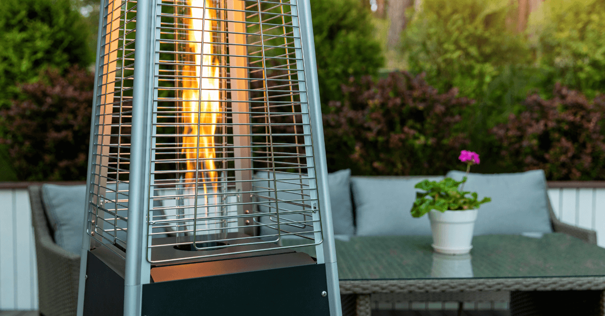 top of free standing patio heater lit up in outdoor space