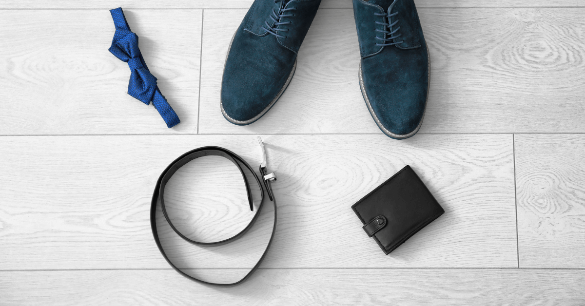 flat lay of mens fashion accessories including wallet, watch, winter scarf and shoes