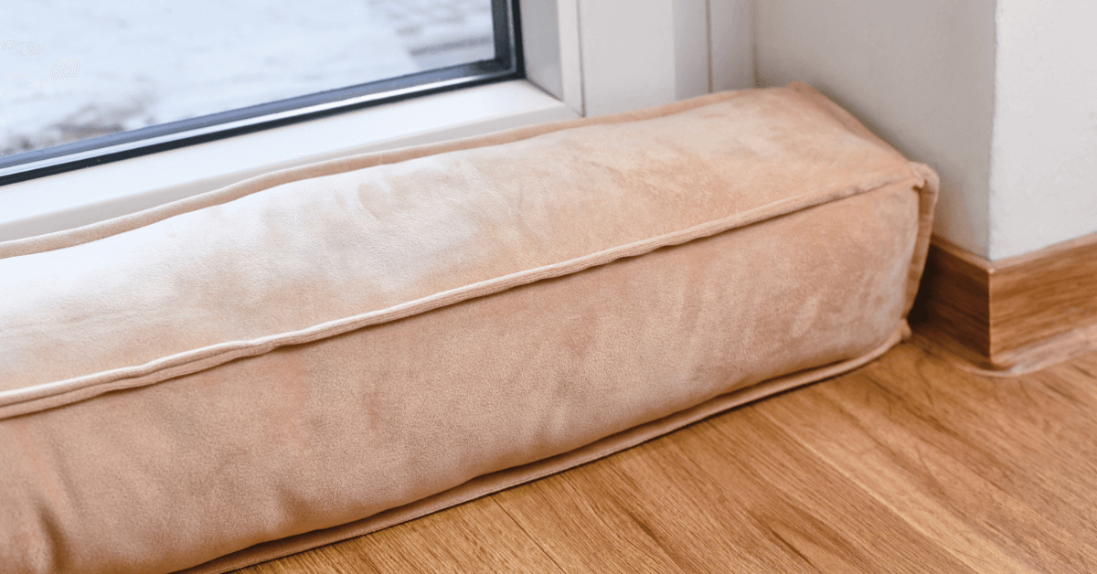 pink velvet draught excluder blocking draught from patio doors