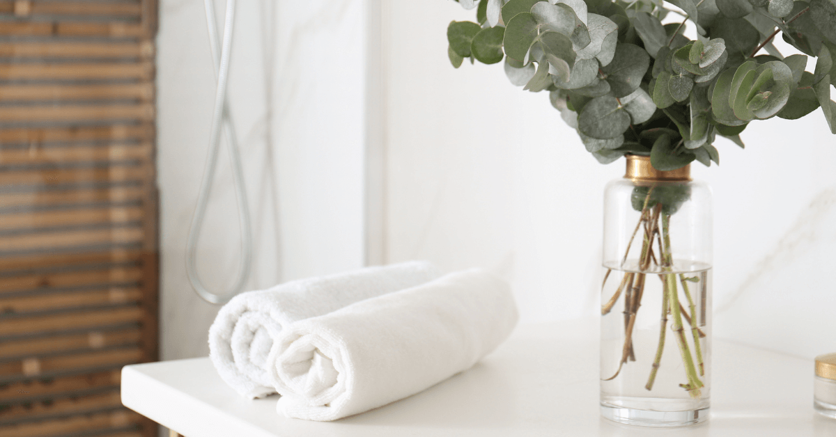 blue, ivory and brown towel bale beside sprig of lavender