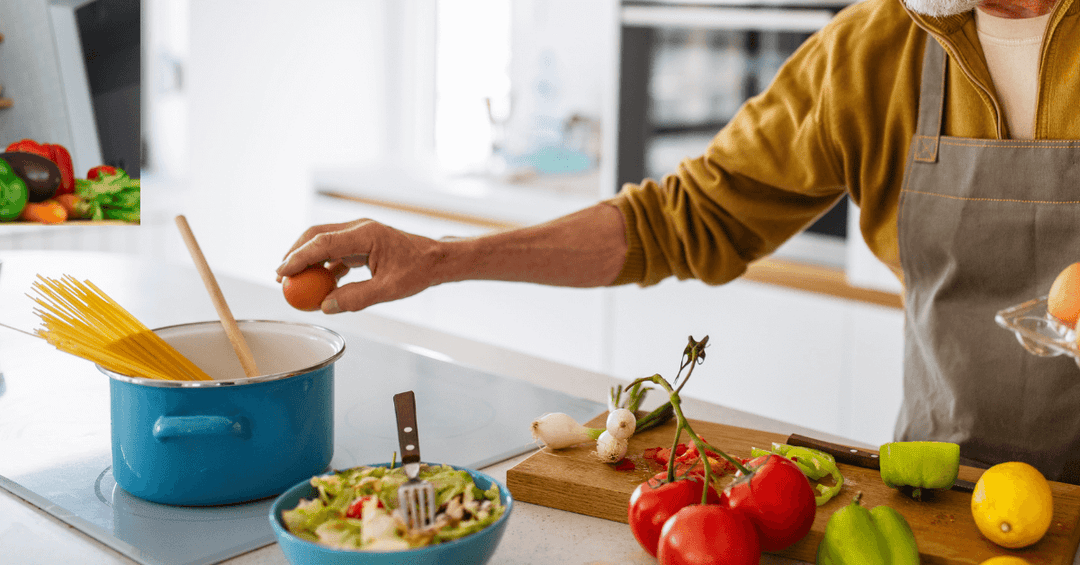 A person making Spaghetti on a hob 