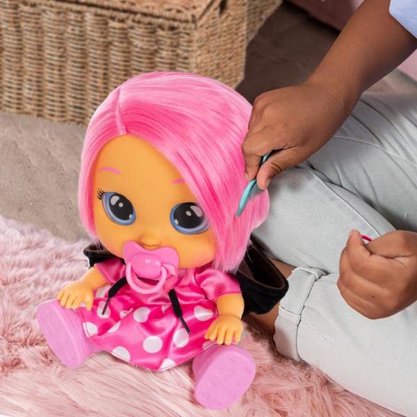 Child brushing the pink hair on Dressy Minnie baby doll