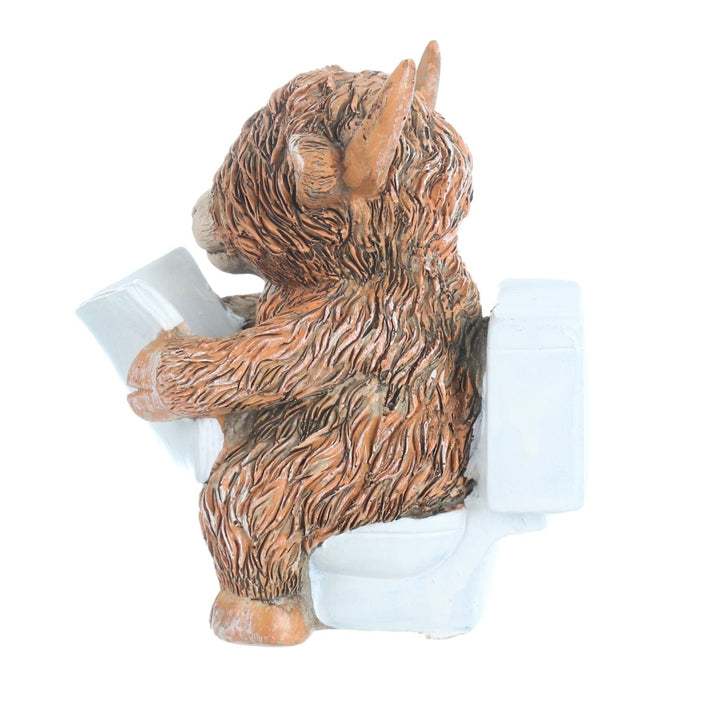 side view of highland cow sitting on toilet reading newpaper, realistic details