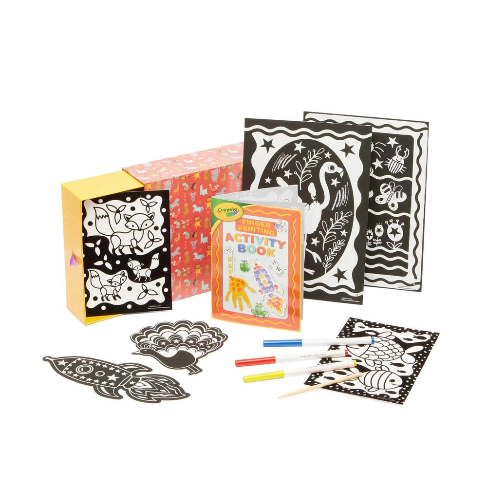 Contents of finger printing art activity box with books and scratch art sheets