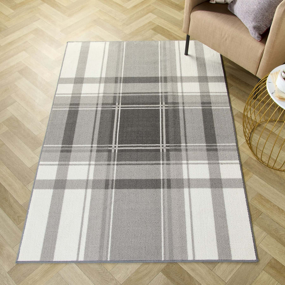 Grey and white checked pattern rug on a hardwood floor