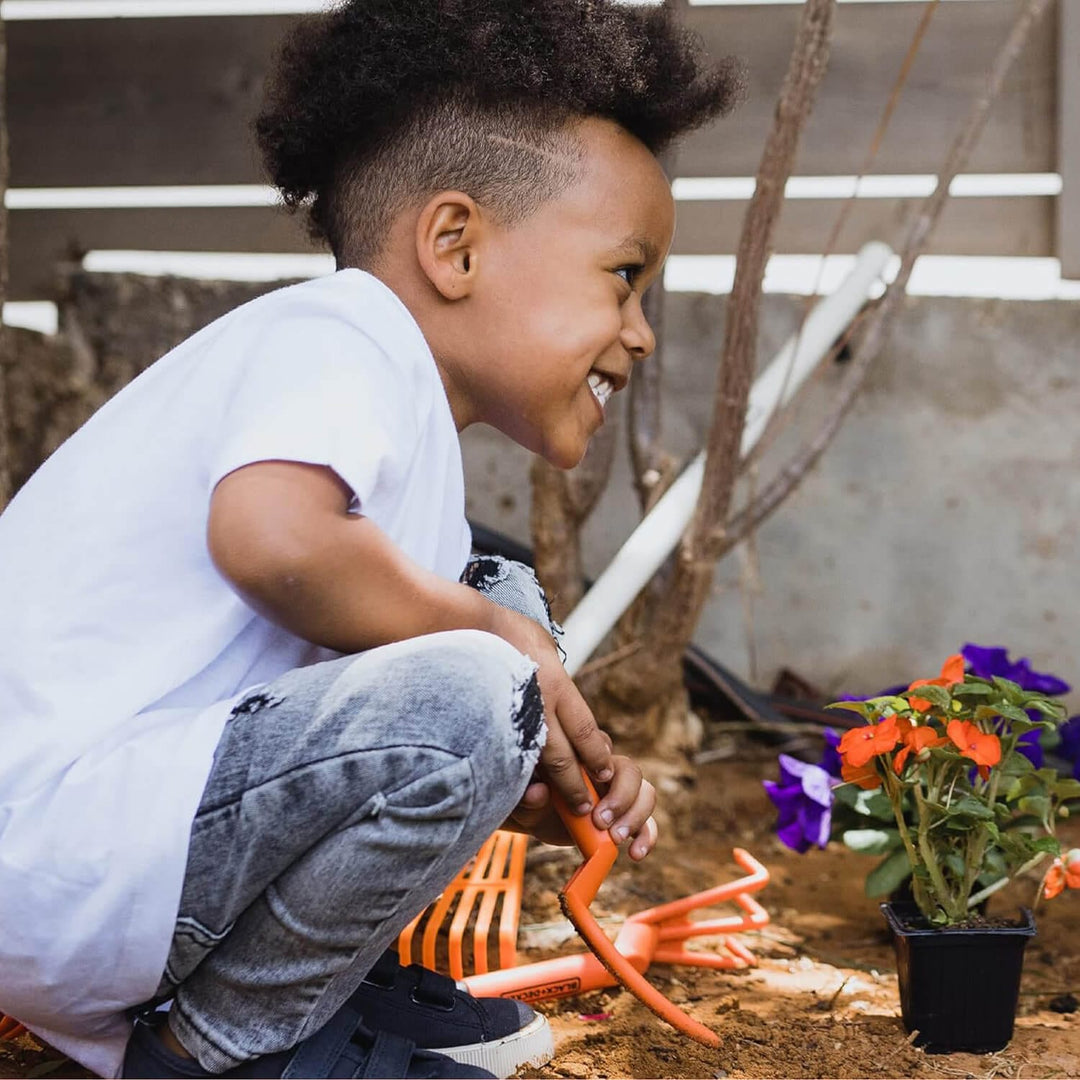 Boy using garden hand tools for kids