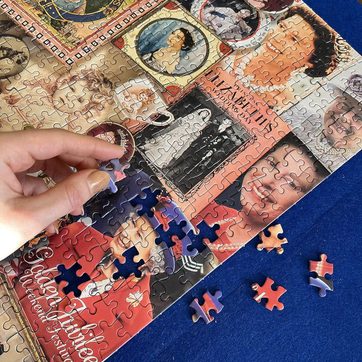 Hand placing a jigsaw piece into a puzzle of the queen