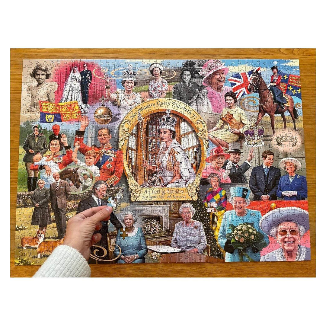 Hand with the last piece of a Queen Elizabeth II jigsaw puzzle