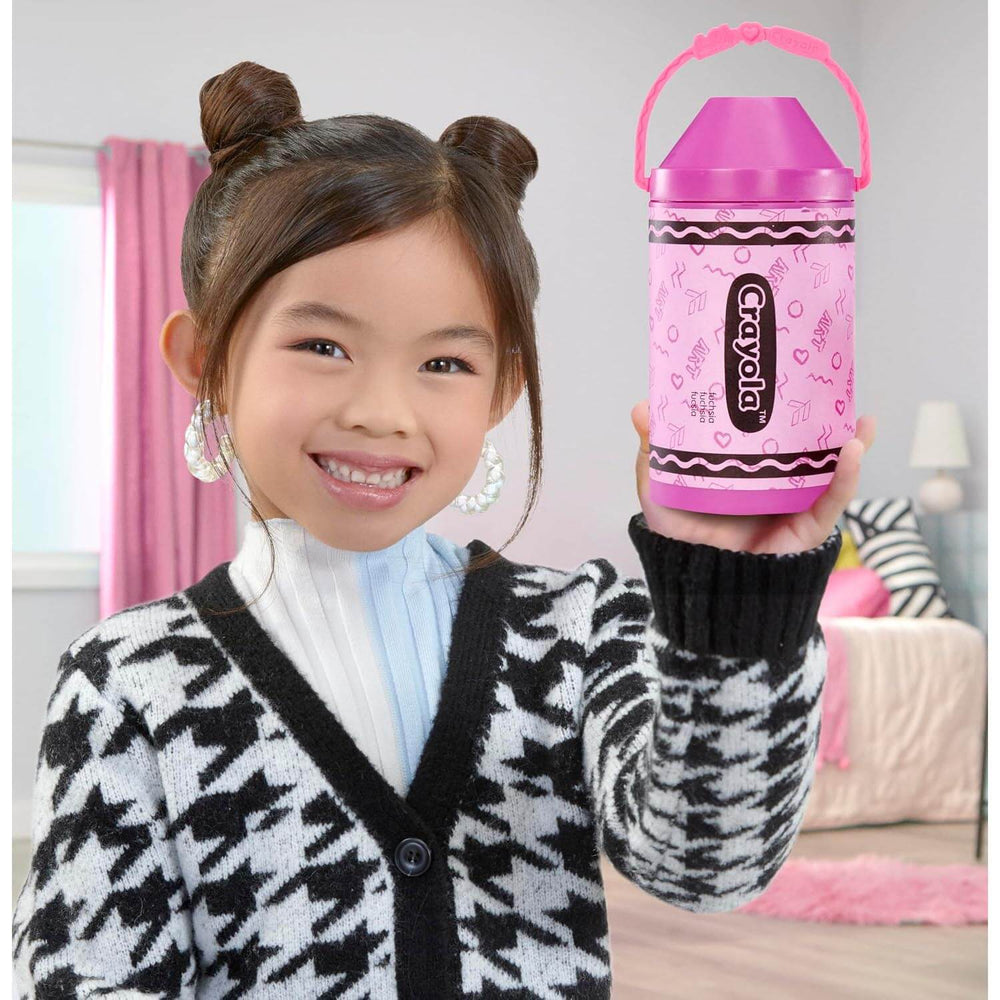 Child holding a crayola crayon shaped carry case in pink