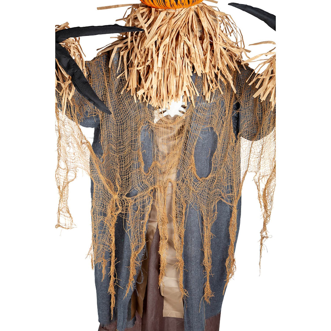 Close up of tattered clothing on a screcrow figure with pumpkin head Halloween decoration
