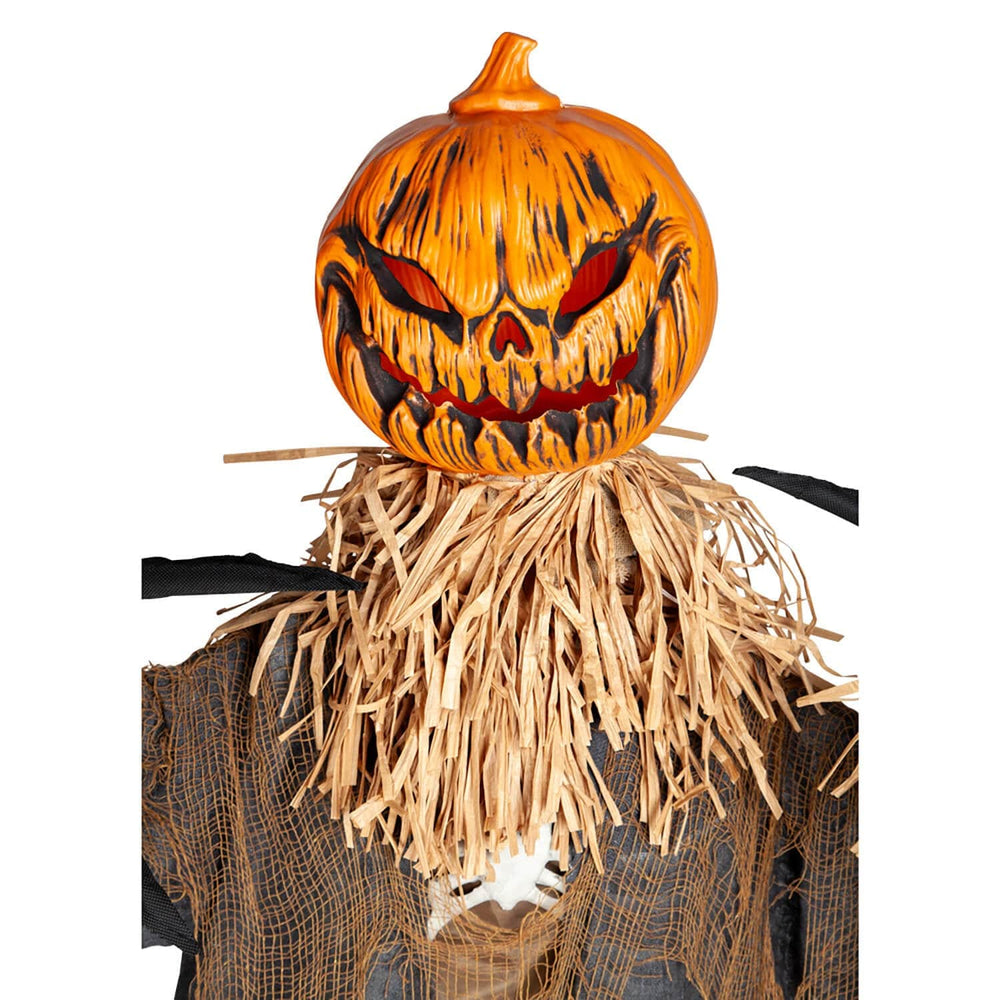 Close up of evil pumpkin scarecrow head with straw stuffing