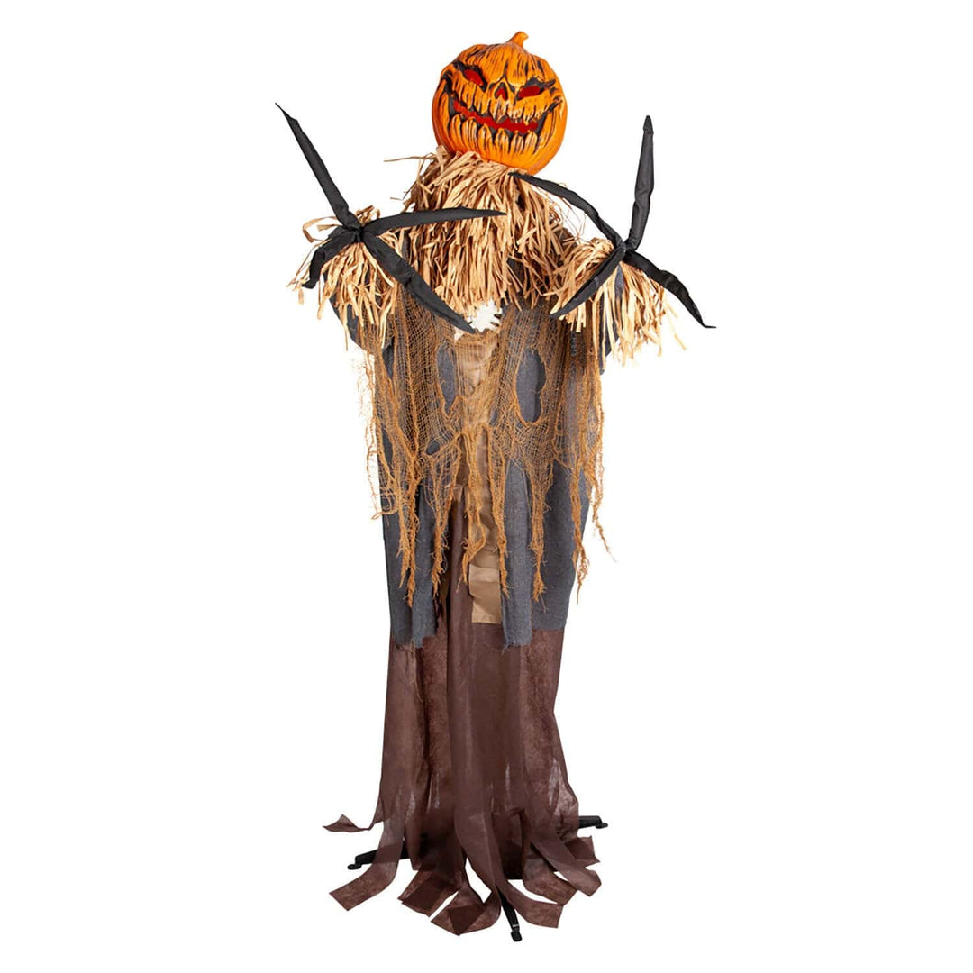 evil scarecrow figure with big orange pumpkin head