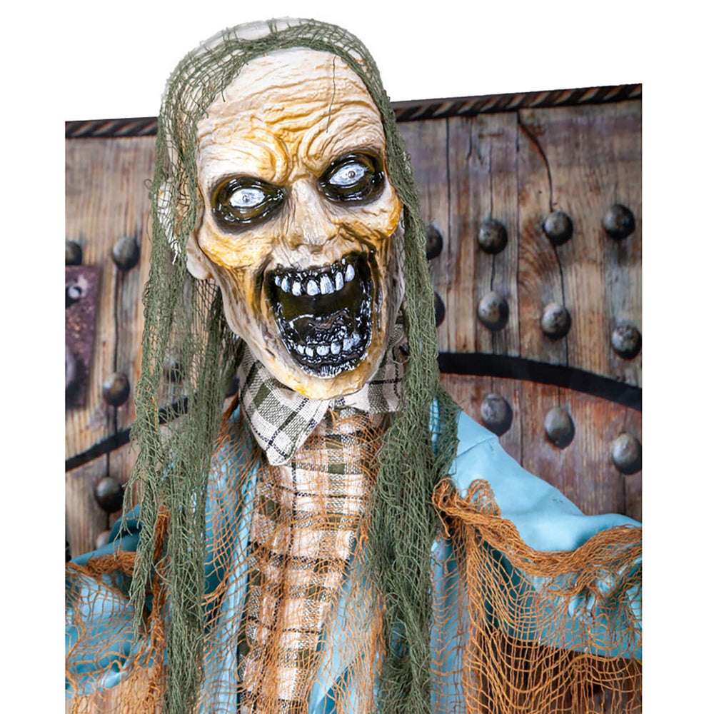Close up of the head of an animated Zombie figure with black gaping mouth 