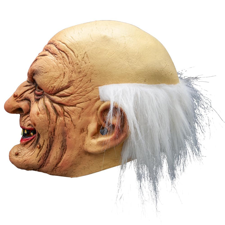 Side view of an old man mask with textured skin and white hair on a white background