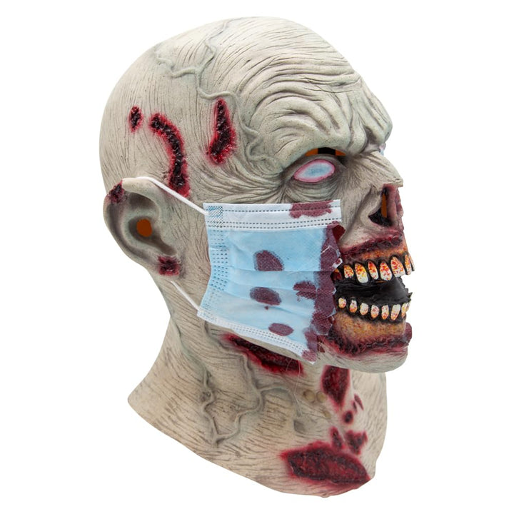 Side view of a Zombie mask with a blue medical face mask over it on a white background