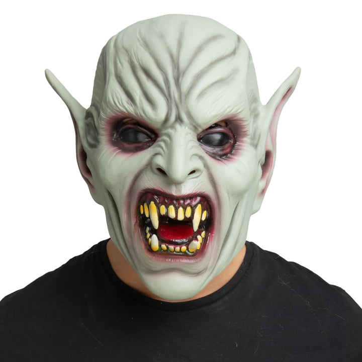 Person wearing a demon Halloween mask with pointed ears and a black shirt on a white background