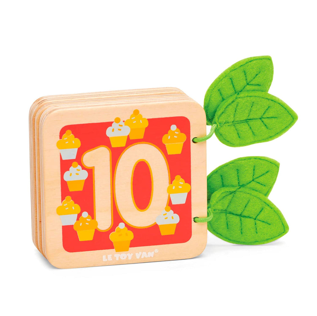 Children's book with number 10 and cupcake illustration, featuring green leaves on a white background