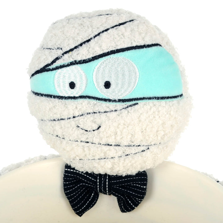 Close up of the face and bow tie of a mummy Halloween treats dish