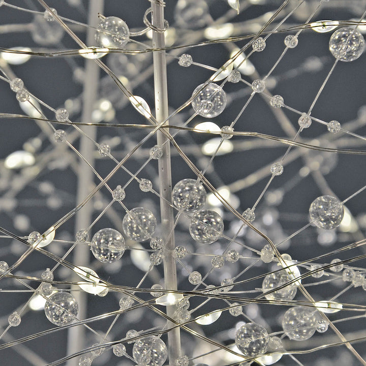 Close up of beads and LED lights on a white wire frame Christmas tree