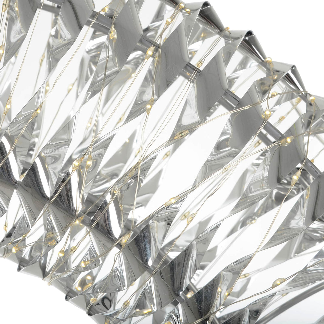 Close up of warm white LED lights on silver foil Christmas decoration