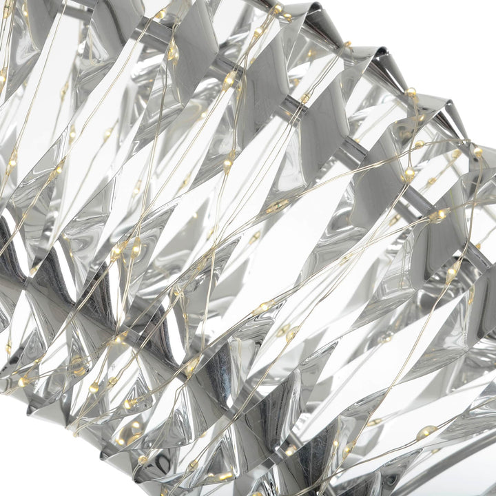 Close up of warm white LED lights on silver foil Christmas decoration