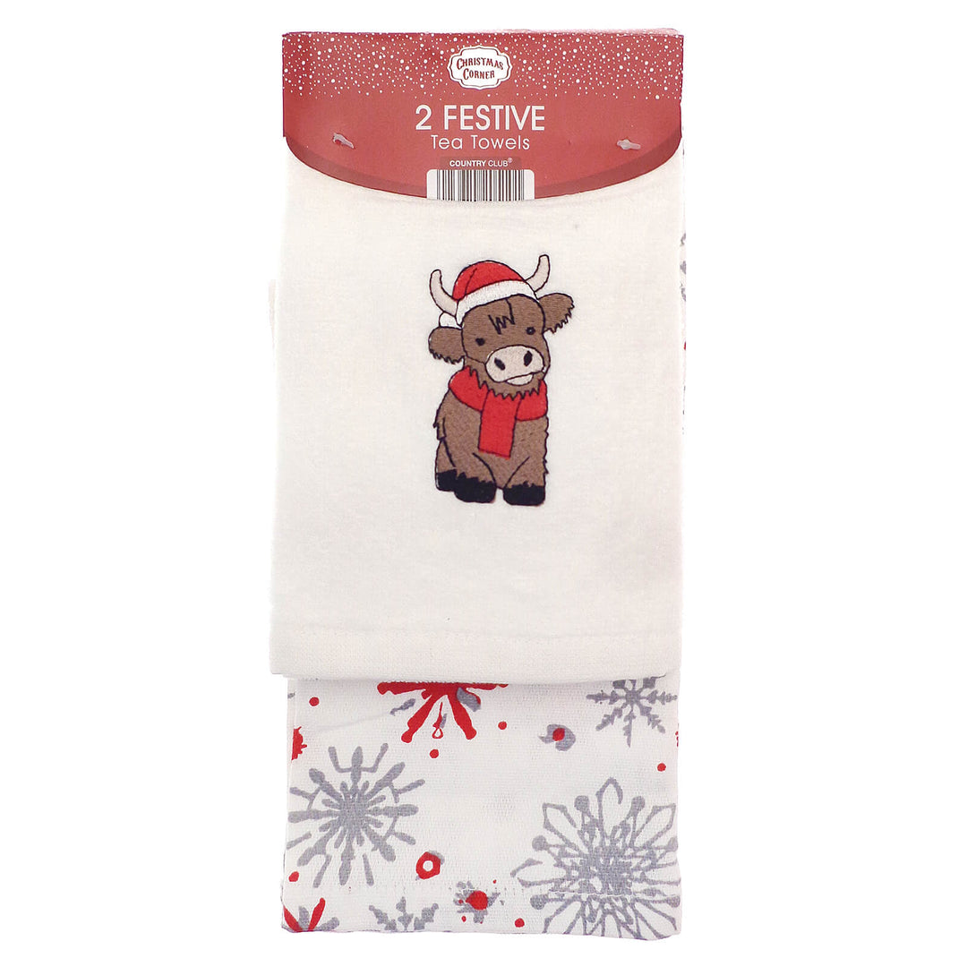 Pack of two festive tea towels with a Highland cow design and snowflake pattern.