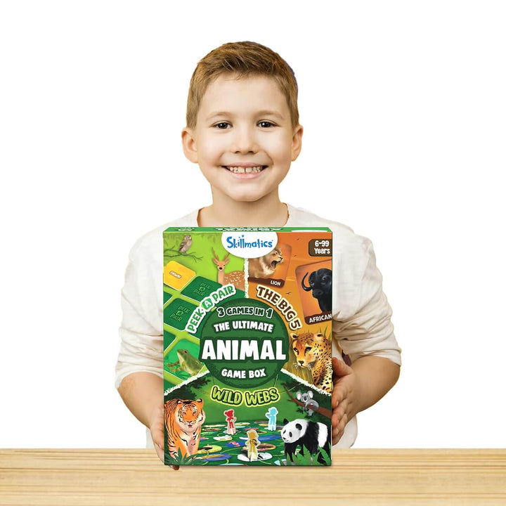 Boy holding the ultimate animal game box on a table