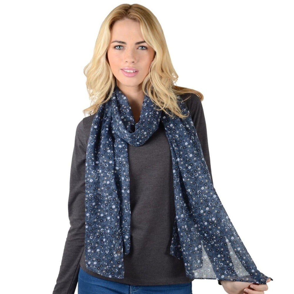 Woman wearing a dark blue scarf with floral pattern on a white background