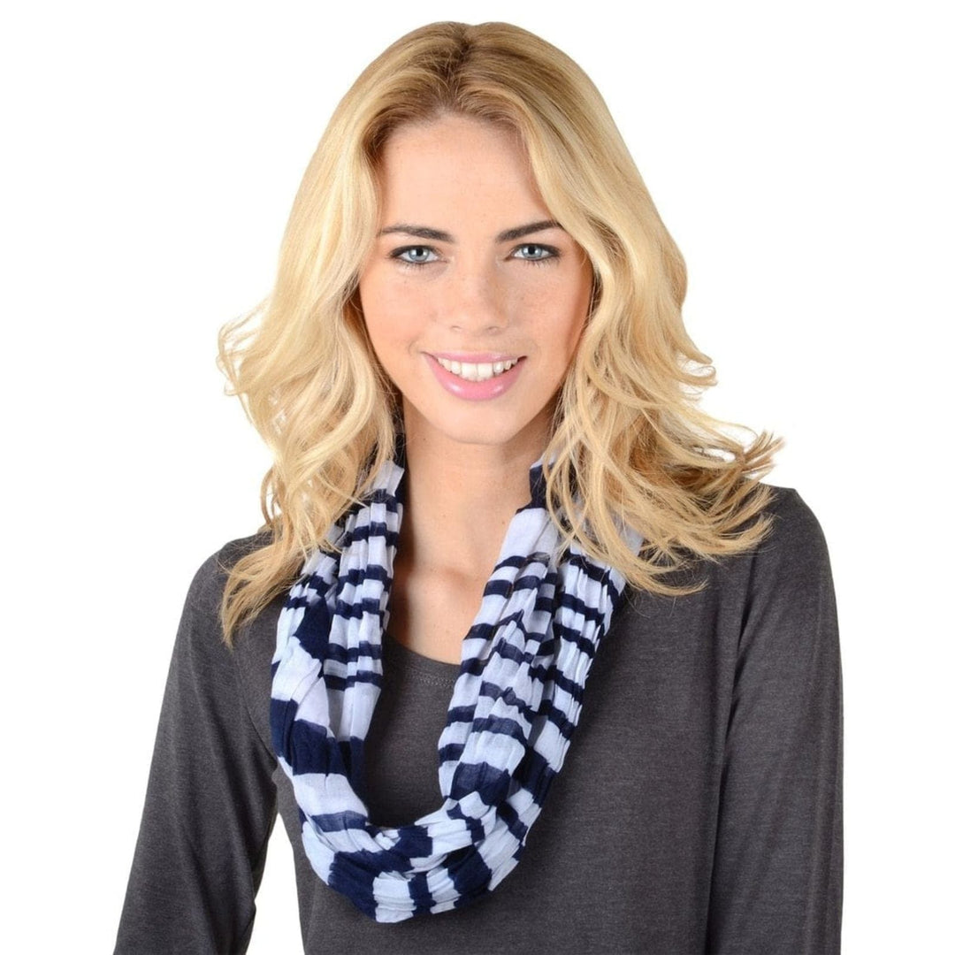 Woman wearing a blue and white striped infinity scarf on a white background