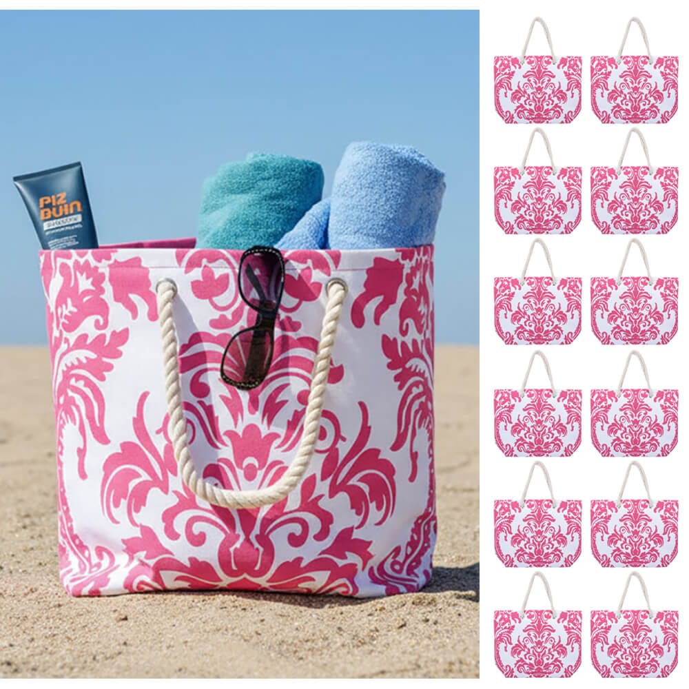 Rose pink floral pattern beach bag with rope handles on a beach with towels and sunglasses