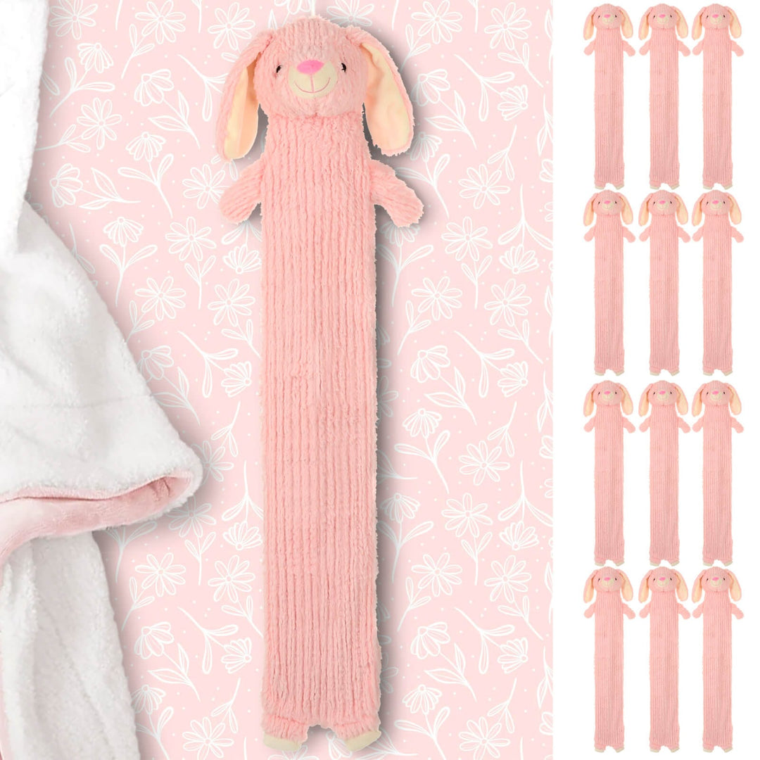 Long pink rabbit hot water bottle on a pink floral bed sheet with white fleece blanket