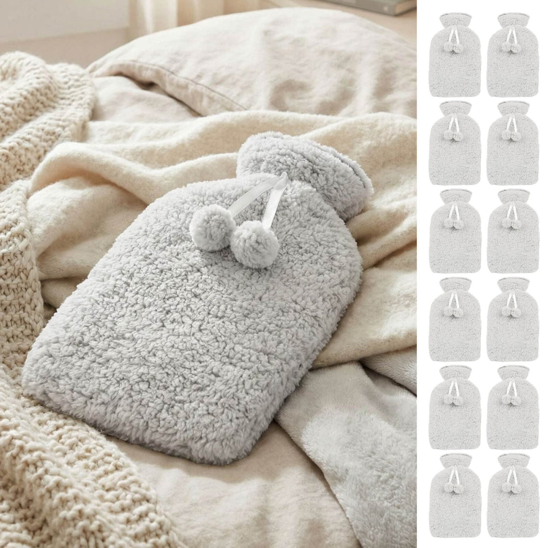 Grey fleece hot water bottle on a bed with 12 smaller hot water bottles down the side