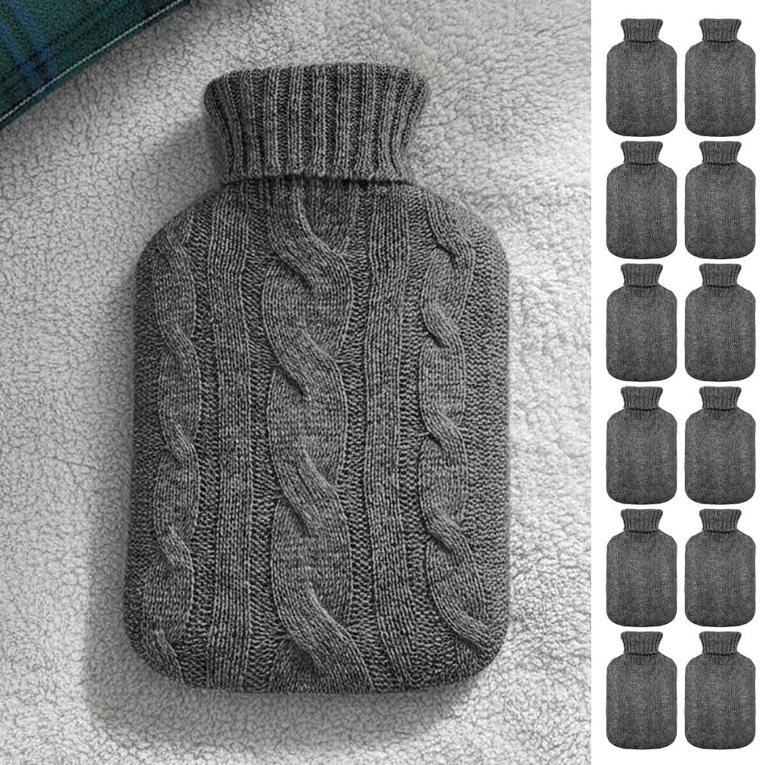 Grey cable knit cover hot water bottle on a fleece blanket with 12 little hot water bottles down one side